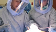 An Orthopaedic faculty and PGY5 Resident in personal protective equipment in the operating room.  