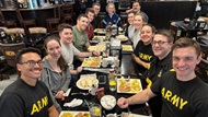 A group of general surgery residents eating breakfast together after a morning workout. 