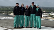 A group of general surgery residents on the helipad at Brooke Army Medical Center. 