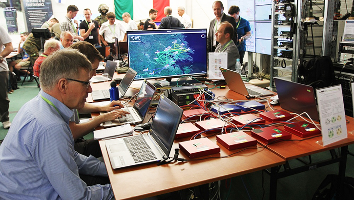 Image of Men and women in room sitting in front of their laptops.