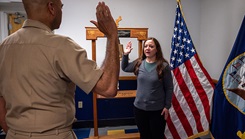  Capt. Todd Levant, deputy commander Navy Recruiting Region East, left, commissions Dr. Isabel Bernal, right, as a General Surgeon into the U.S. Navy.