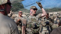 U.S. Army Reserve Lt. Col. Robert Fincher, commander of 934th Forward Resuscitative Surgical Detachment, teaches his Soldiers the capabilities of specific camo netting that provides concealment from drones flying in the area 