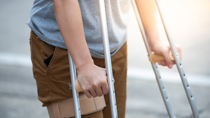 Image of Military personnel using crutches.