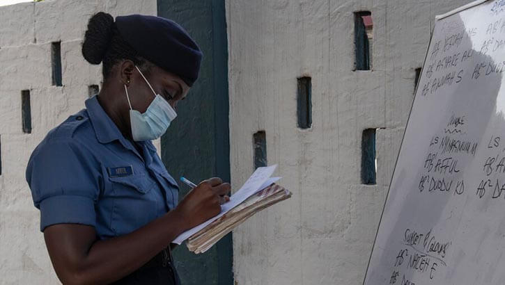 Image of Ghanaian sailor taking notes while standing watch.