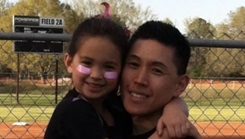 U.S. Air Force Lt. Col. Tony Lawrence holding his daughter Dori 