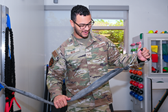 U.S. Air Force Senior Airman Christopher Neal, 42nd Medical Group physical medicine technician, prepares to demonstrate strength training exercise