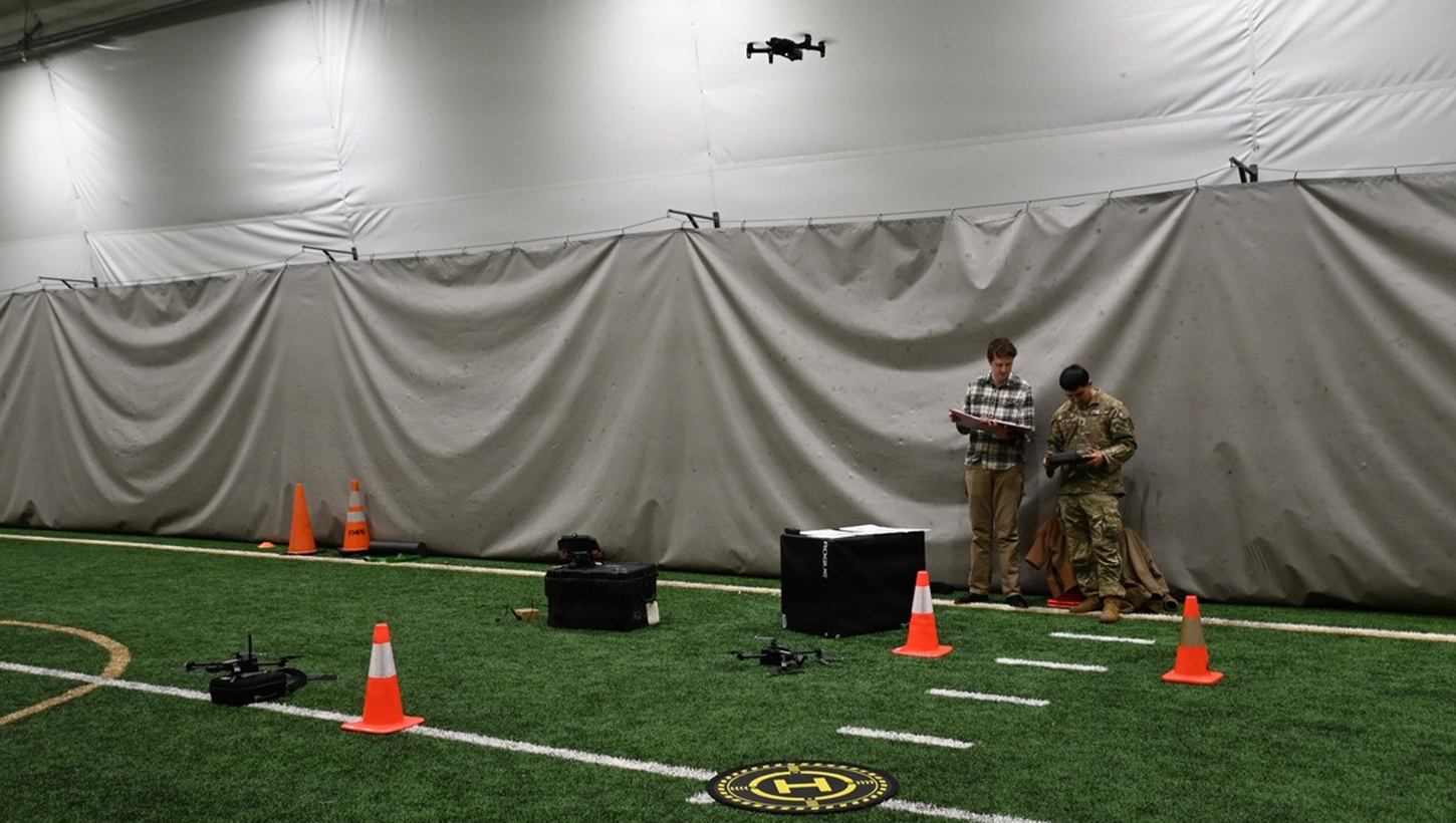 Military personnel flying a drone