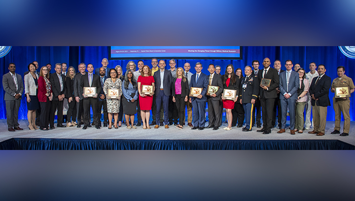 Image of Researchers with the Military Health Systems posing for a photo.