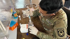 U.S. Army Staff Sgt. Matthew Pascual, a preventive medicine specialist with the Walter Reed Army Institute of Research Armed Forces Research Institute of Medical Sciences, processes samples for respiratory virus testing at Nimmarnkolayut Camp, Sa Kaeo, Thailand.