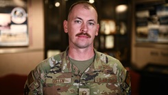 U.S. Air Force Master Sgt. Michael Osten, 21st Medical Group Operational Support Team flight chief, stands in front of an award display at Schriever Space Force Base, Colorado, Oct. 30, 2024. Osten worked for 13 years as a mental health technician before being selected to commission as a Public Affairs officer through the Senior Leader Enlisted Commissioning Program. (U.S. Space Force photo by Senior Airman Justin Todd)