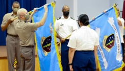 Military personnel uncasing the DHA Low Country Market colors