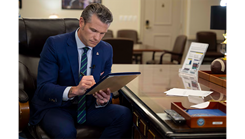 Defense Secretary Pete Hegseth signs a memorandum regarding medical waivers at the Pentagon, April 24, 2025.