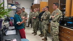 Dr. Rodrigo Mateo leads Uniformed Services University first-year medical students on an introductory tour of the medical innovation student lab