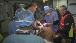 U.S. Navy sailors from Fleet Surgical Team 6 treat a simulated patient aboard the amphibious assault ship USS Bataan in the operating room during a medical mass casualty drill. Sailors from USS Bataan and Fleet Surgical team 6 participated in an all-day medical training evolution to increase operational readiness. (Photo by U.S. Navy Mass Comm.  Spc. Seaman Apprentice Levi Decker)