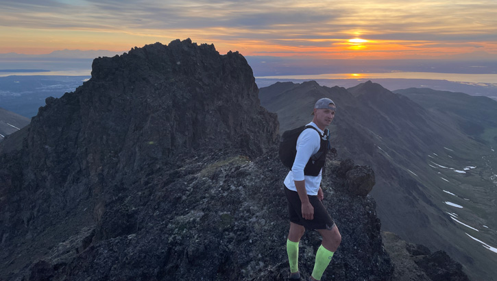 Image of U.S. Coast Guard Lt. Cmdr. Duane Zitta on top of a mountain.