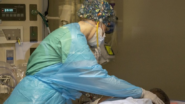 Image of Military health personnel checking patients vitals.