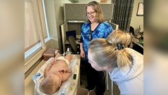 Audrey Sundbye, a certified lactation consultant at Blanchfield Army Community Hospital,  checks the weight of U.S. Army Spc. Jaqueline Kerchner’s baby following his feeding at a Mom & Me meeting in the hospital on March 20. Mom & Me provides breastfeeding mothers of infants age newborn to 12 months, walk-in access to the hospital’s lactation consultants. (Photo: Maria Christina Yager, Blanchfield Army Medical Hospital)