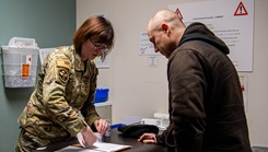 U.S. Air Force Staff Sgt. Nicholette Drew, 374th Healthcare Operation Squadron immunizations technician, cares for a patient at the 374th Medical Group immunizations clinic at Yokota Air Base, Japan, on Jan. 9, 2024. (Photo by U.S. Air Force Airman 1st Class Alexzandra Gracey)