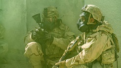 Military personnel in chemical cloud