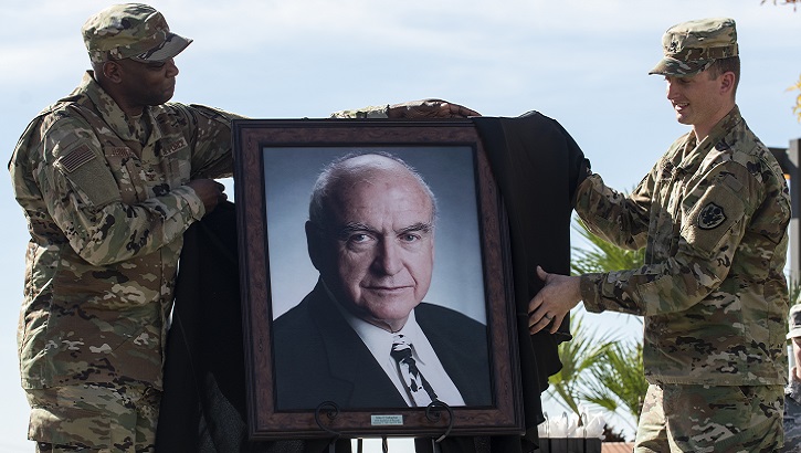 Image of Air Force Col. Alfred Flowers, 99th Medical Group commander, and Army Staff Sgt. Michael O’Callaghan, (grandson of the former Gov. O’Callaghan) reveal a portrait of O’Callaghan during a ceremony celebrating the Mike O’Callaghan Military Medical Center’s 25th Anniversary on Nellis Air Force Base, Nevada, Nov. 12, 2019. The portrait will hang in the MOMMC to honor the center's namesake. (U.S. Air Force photo by Senior Airman Kevin Tanenbaum).