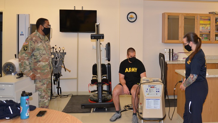 Image of Military health personnel wearing face mask attending occupational therapy.