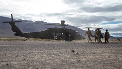 Military personnel carry items from medical supply drone Project Crimson