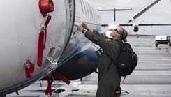 U.S. Air Force Maj. Molly Sexton conducts pre-flight inspections