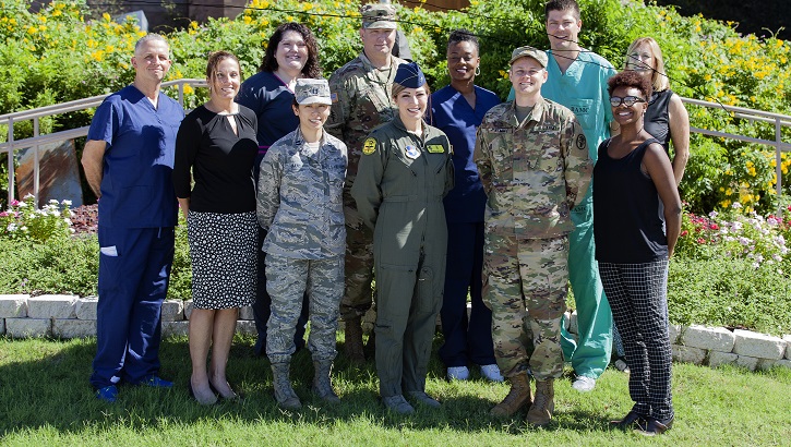 Image of Military Personnel wearing face mask and posing for a picture.