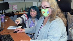 Military personnel looking at a computer