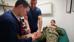 U.S. Navy Cmdr. Daniel Griffin, an orthopedic surgeon at Navy Medicine and Readiness Training Command Rota, Spain, demonstrates orthopedic assessment skills to U.S. Navy Hospitalman Jaxon Drezek, during a readiness training exercise. 