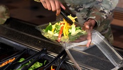 A person serving himself a salad