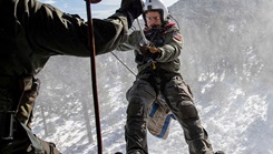 U.S. Navy Hospital Corpsman Brian Romero, rappels 80 feet from a helicopter during a reenlistment ceremony and search-and-rescue training flight on Jan. 27, 2025