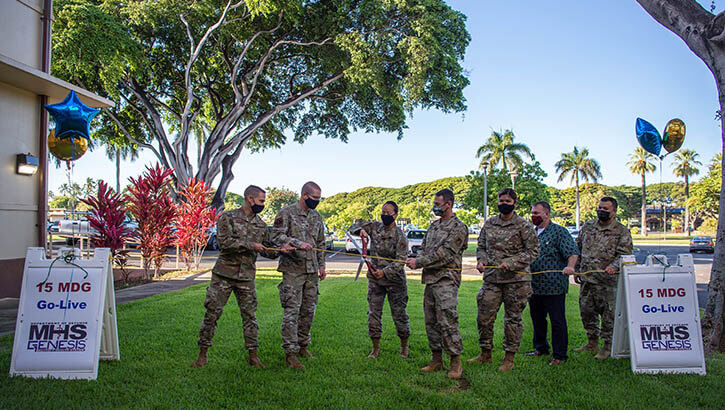 Image of Military personnel cutting the cord during the system's launch.