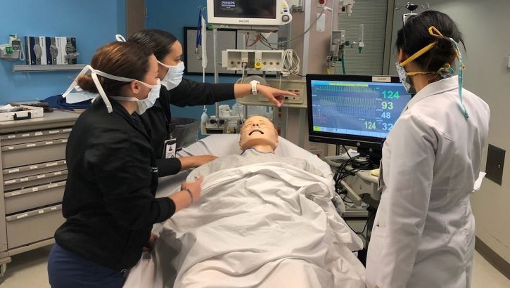 Image of Military health personnel reading a medical machine.