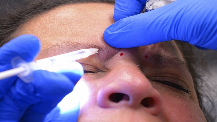 Image of Military personnel receiving treatment for headaches.