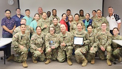 Nurses from Tripler Army Medical Center pose with an award and a certificate commemorating the hospital's designation as a Pathway to Excellence organization on Aug. 27, 2024. (Defense Health Agency photo by Khinna Kaminske)