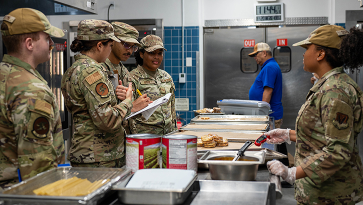 U.S. Airmen assigned to the 325th Operational Medical Readiness and Force Support Squadrons review food temperatures during a routine food safety inspection at the dining facility on Tyndall Air Force Base