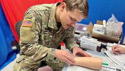 U.S. Army 1st Lt. George Mata practices intradermal injection techniques using a training simulator during the Bayne-Jones Army Community Hospital Skills Fair