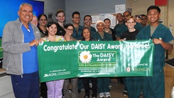 Walter Reed's 3 Center nursing team members and director for nursing services celebrate the unit's recent DAISY Award recipient for extraordinary nursing care, U.S. Army 1st Lt. Jakob Jackson (back row, third from left) at the ward.