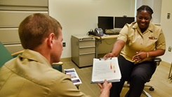 U.S. Navy Hospital Corpsman 2nd Class Fabiola Michel, a behavioral health technician at U.S. Naval Hospital Guam’s mental health department, shares information about the crisis stabilization unit program and services with U.S. Lt. Cmdr. Marvin Weniger