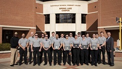 U.S. Naval Medical Forces Atlantic Command Master Chief Lamar Bethel, service members, and Billy Eldridge, an instructor at Fayetteville Technical Community College, pose for a photo