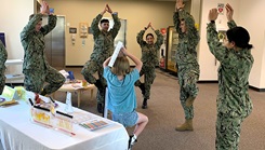 Seeing the forest with all the trees…hospital corpsmen assigned to Naval Hospital Bremerton join a young beneficiary in an impromptu tree pose designed to test balance and stability during Health Promotion’s Health Fair