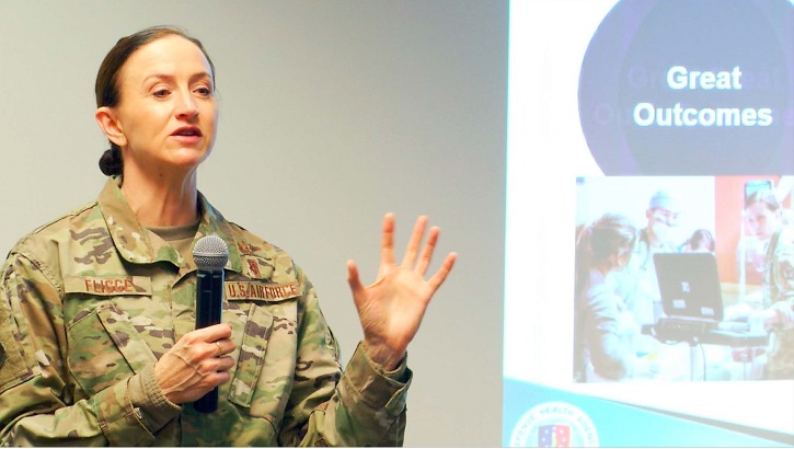 Image of Military personnel speaking through a microphone.