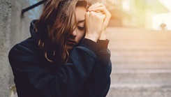 A woman holding her hands near her face