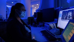 Lorie Falaminiano, an MRI technologist assigned to Naval Medical Center San Diego (NMCSD), conducts an MRI scan of a patient's brain at the NMCSD hospital. 