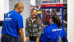 A recovering Airman and caregiver talk with organizations during an Air Force Wounded Warrior CARE Event