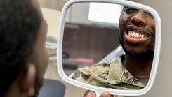 Spc. Brandon Wade smiles in the mirror 