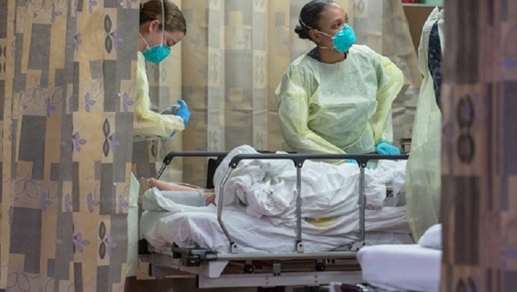 Image of Hospital personnel treating a patient on a stretcher.