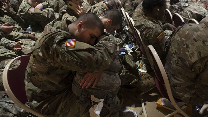 Image of A trainee attempts to get a little sleep as he waits for transportation at the Joe E. Mann Ballroom Dec. 18. He is one of thousands of Initial Entry Training Soldiers across the Army who are headed home on leave for the holidays. .