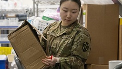 Army Reserve Pfc. Yebin Mazza, a medical logistics specialist with the Newark, Del. based 7379th Blood Detachment, moves and reorganizes medical supplies at the Alexander T. Augusta Military Medical Center